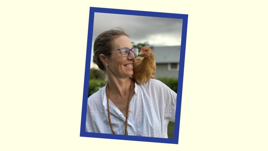 Image of Dr. McCarren with her hair in a bun. There is a chicken on her shoulder.