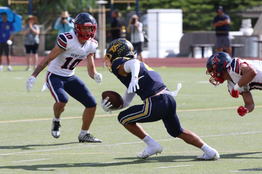 Punahou player with posession of the ball avoids defenders